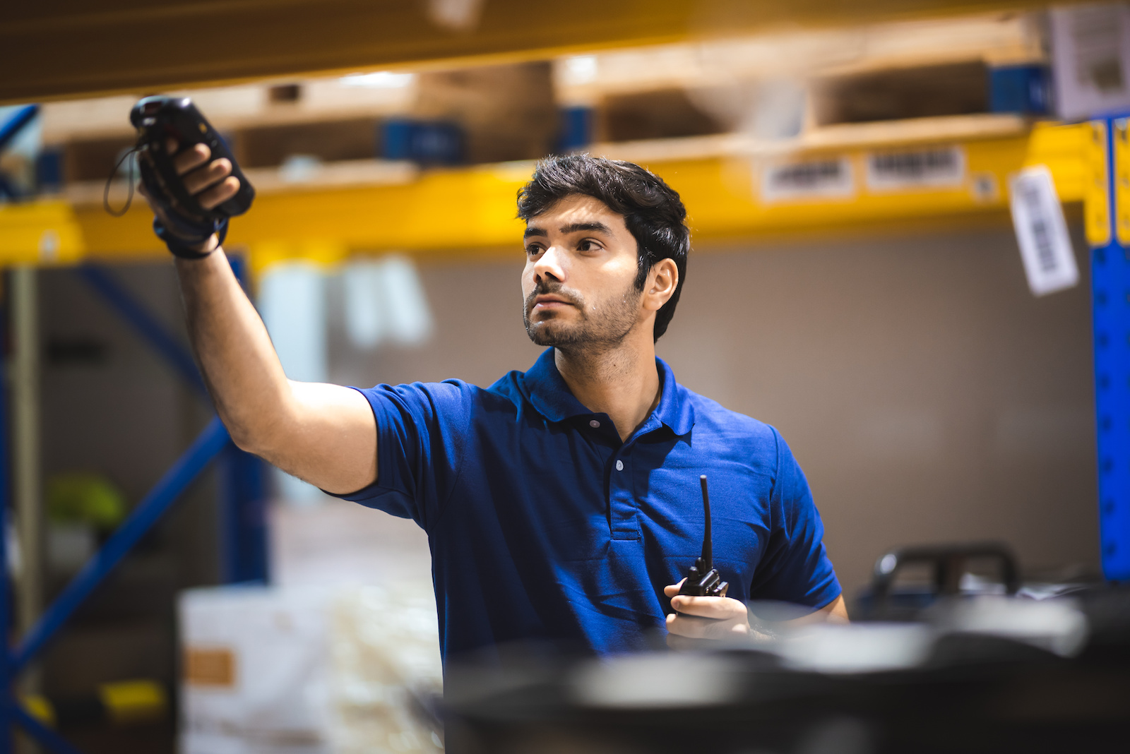 warehouse worker using bar code scanner to analyze newly arrived goods for further placement in storage department, logistic working at warehouse.